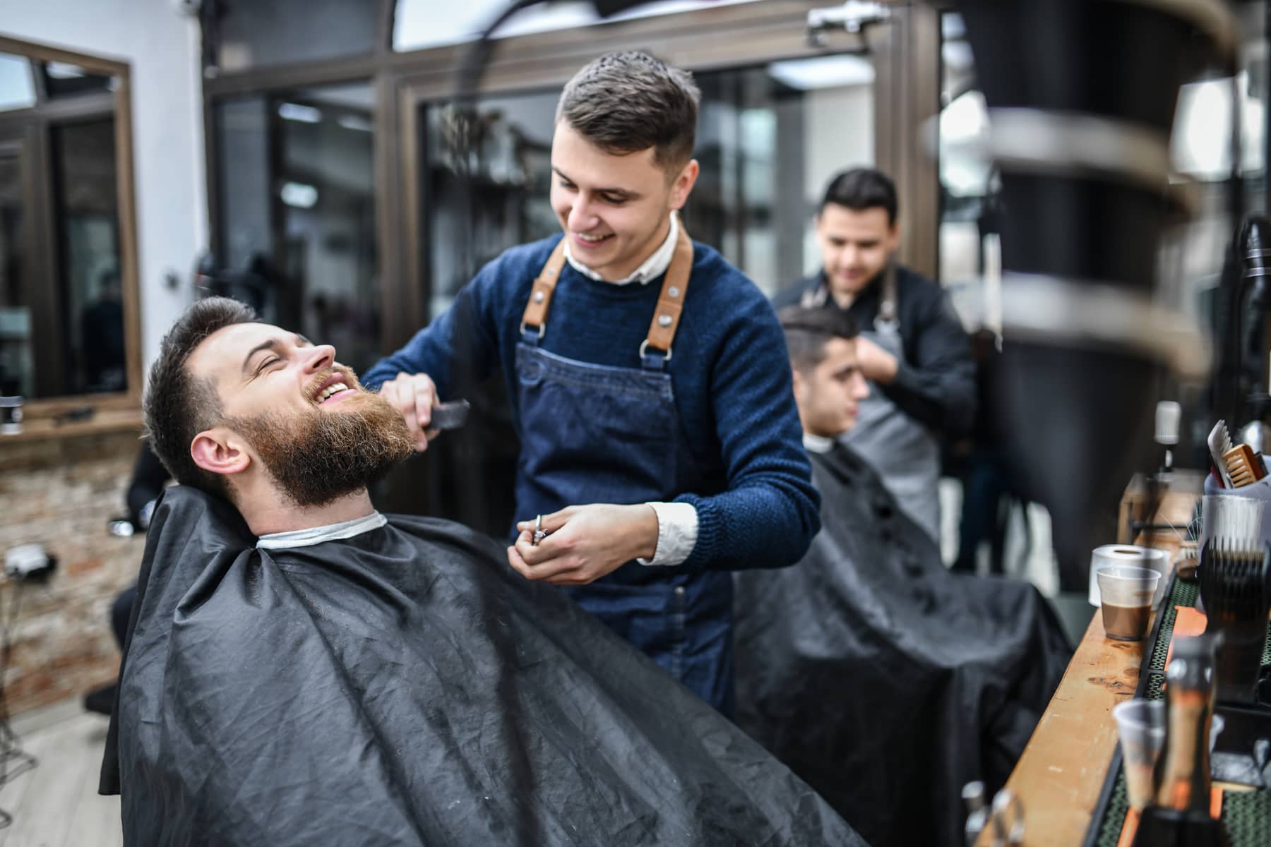 A barber talking with a client during an appointment